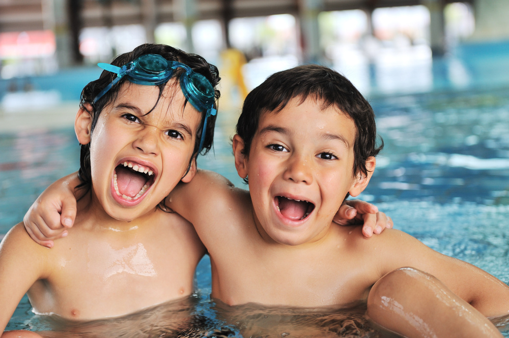 Summertime and swimming activities for happy children on the pool