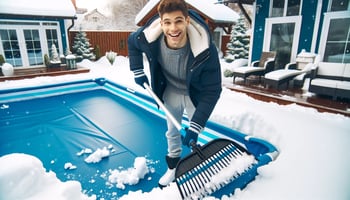 A cheerful person clearing snow from a pool cover, showcasing effective snow and ice management for pool maintenance.